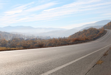 Photo of Landscape with asphalt road leading to mountains