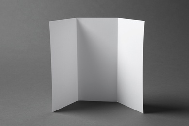 Blank brochure on gray background. Mock up for design