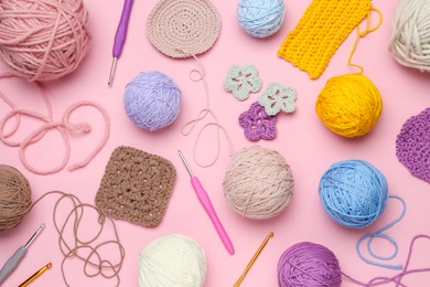 Photo of Flat lay composition with knitting threads and crochet hooks on pink background