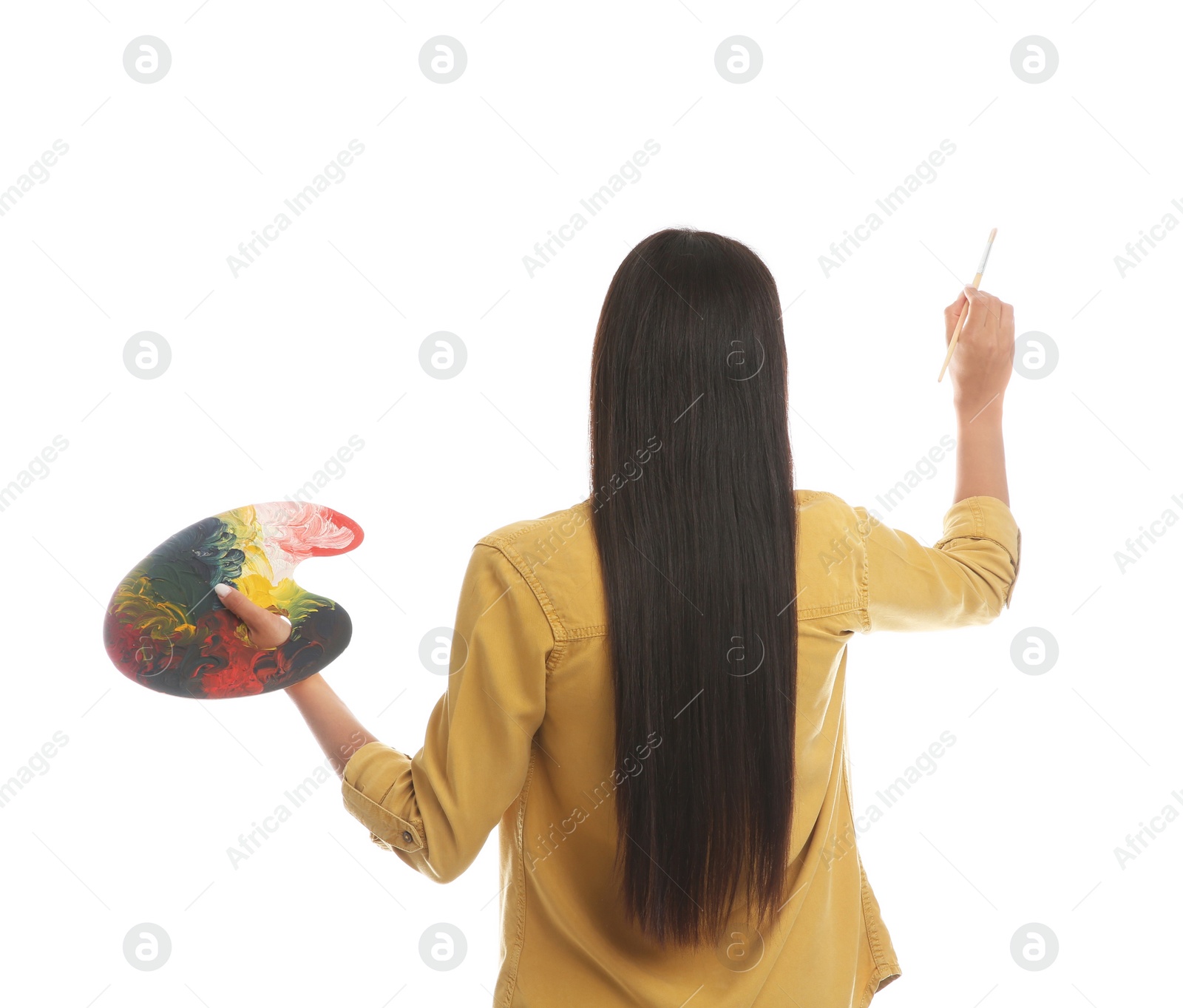 Photo of Young woman drawing with brush on white background, back view