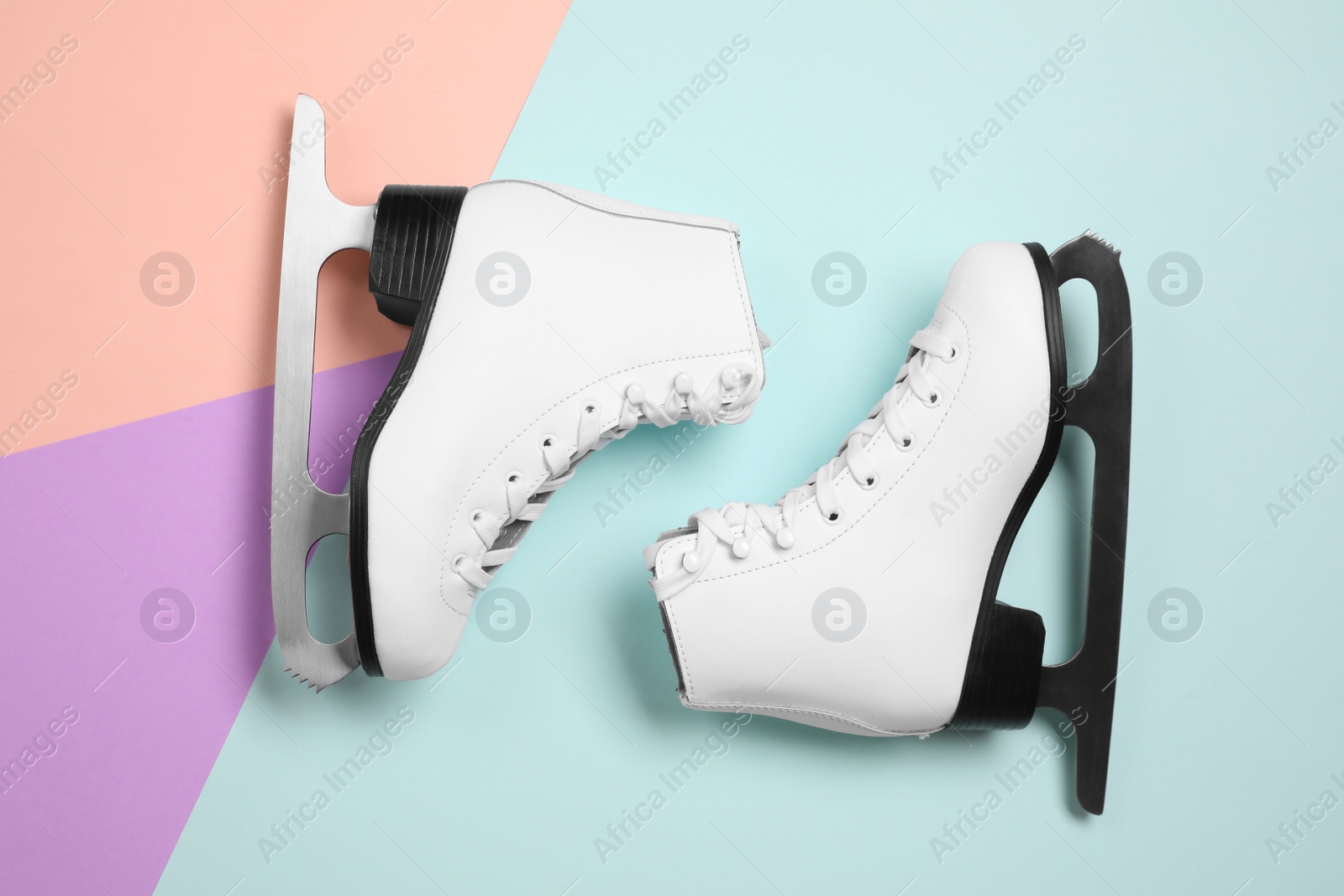 Photo of Pair of skates on color background, flat lay