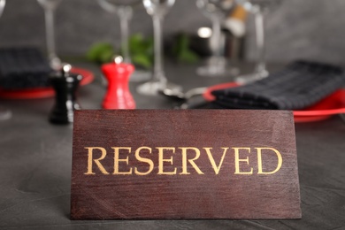 Photo of Table setting with RESERVED sign in restaurant