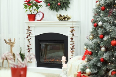 Beautiful living room interior with burning fireplace and Christmas decor