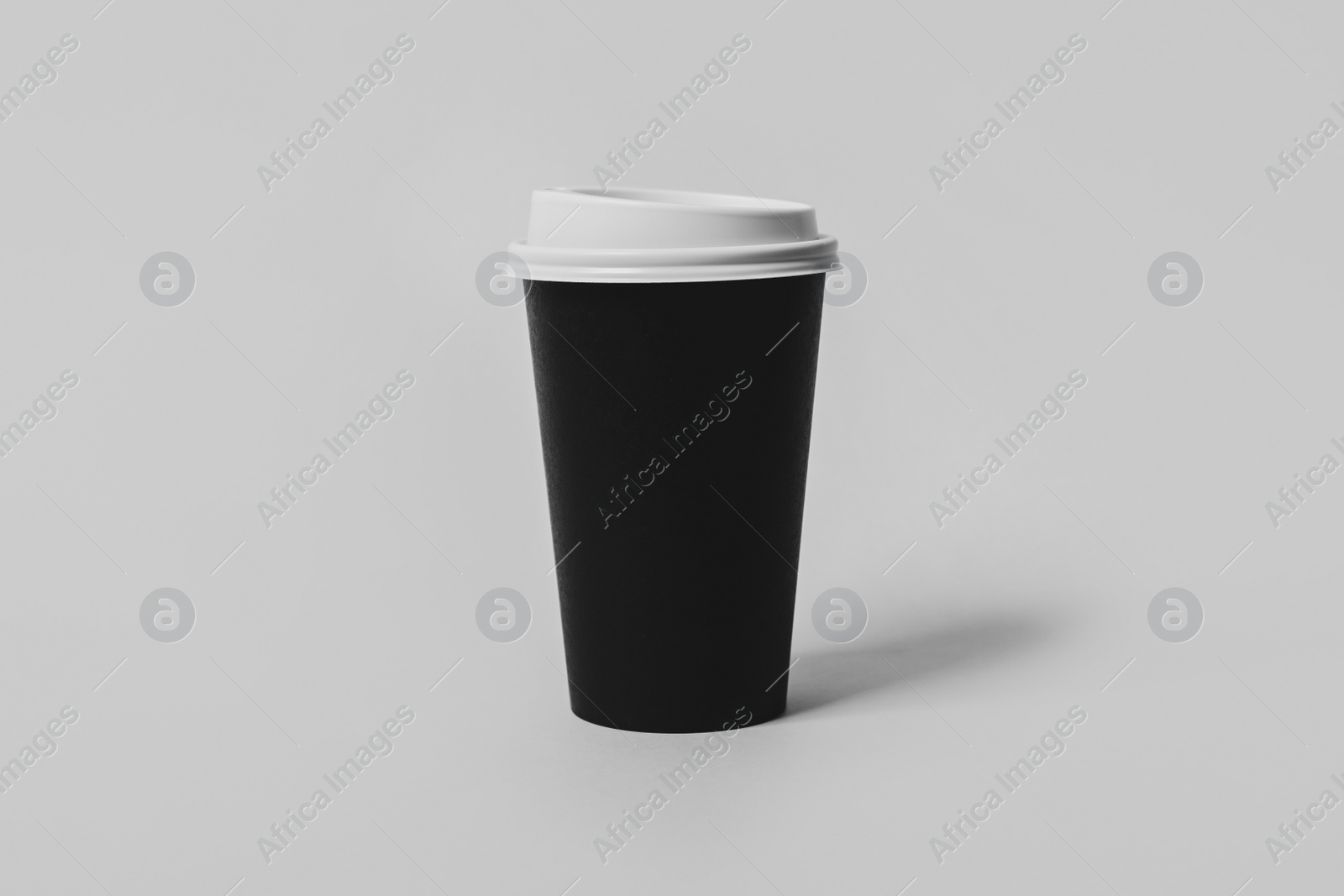 Photo of Takeaway paper coffee cup on light grey background