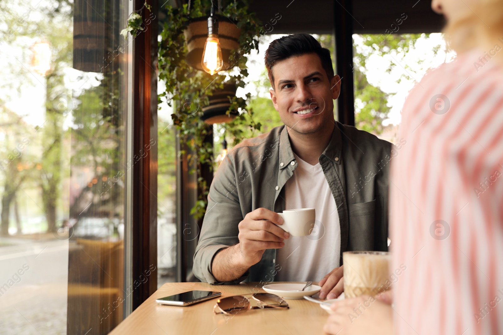 Photo of Lovely couple spending time at cafe in morning