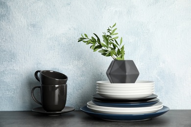 Photo of Set of dinnerware on table against light background. Interior element