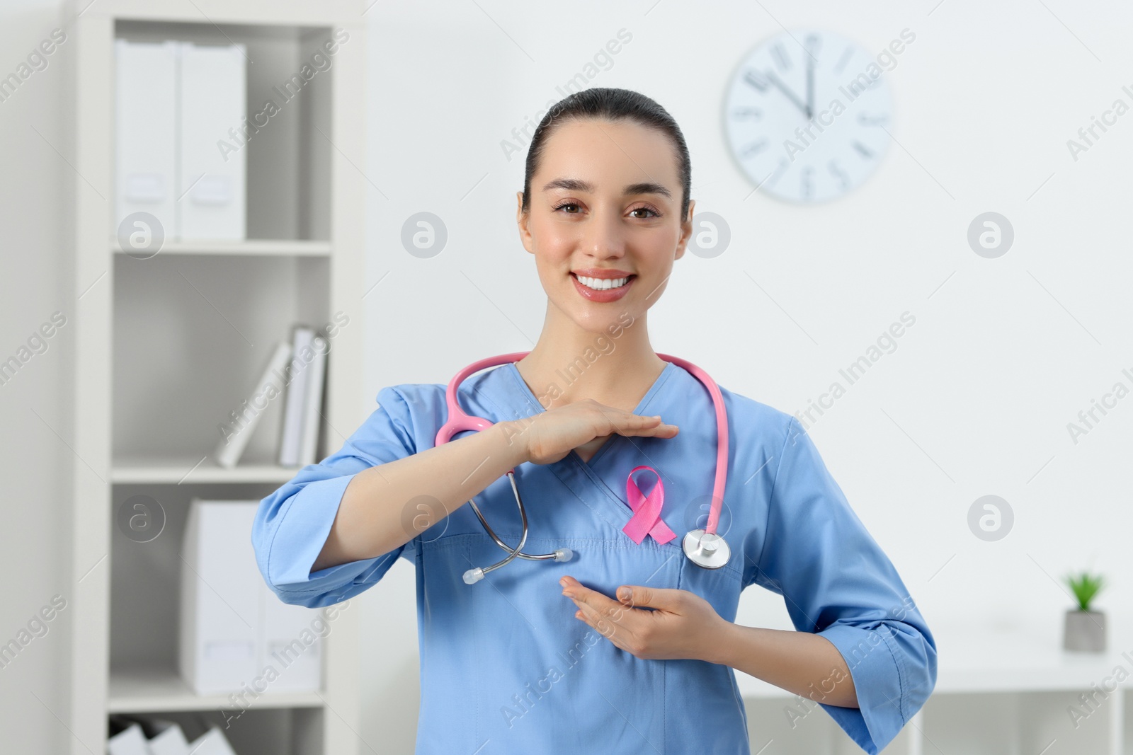 Photo of Mammologist with pink ribbon in hospital. Breast cancer awareness