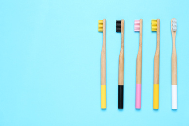 Photo of Toothbrushes on light blue background, flat lay. Space for text