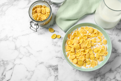 Flat lay composition with tasty corn flakes on marble table, space for text