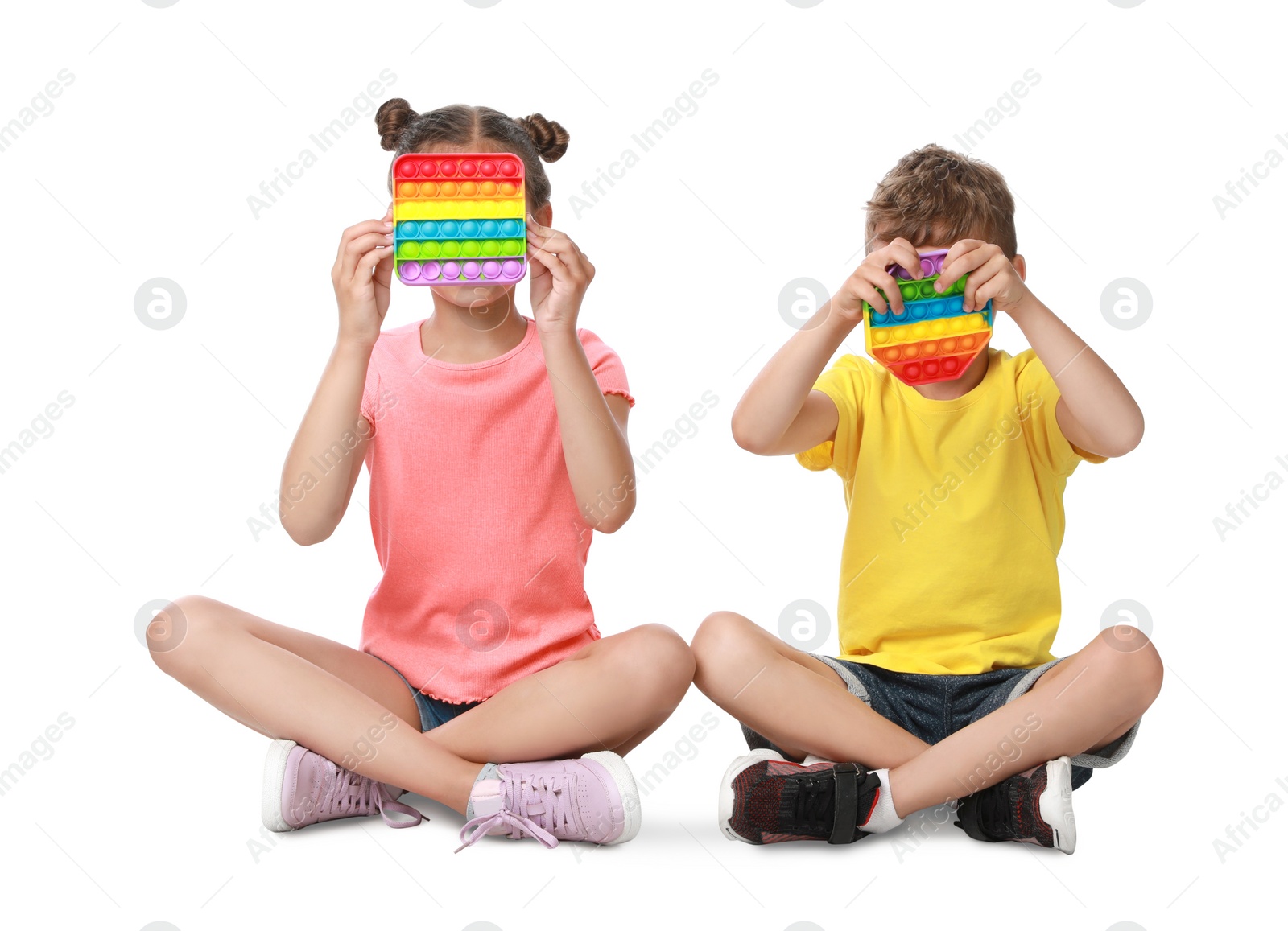 Photo of Children with pop it fidget toys on white background