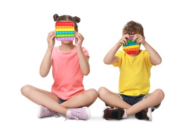 Children with pop it fidget toys on white background