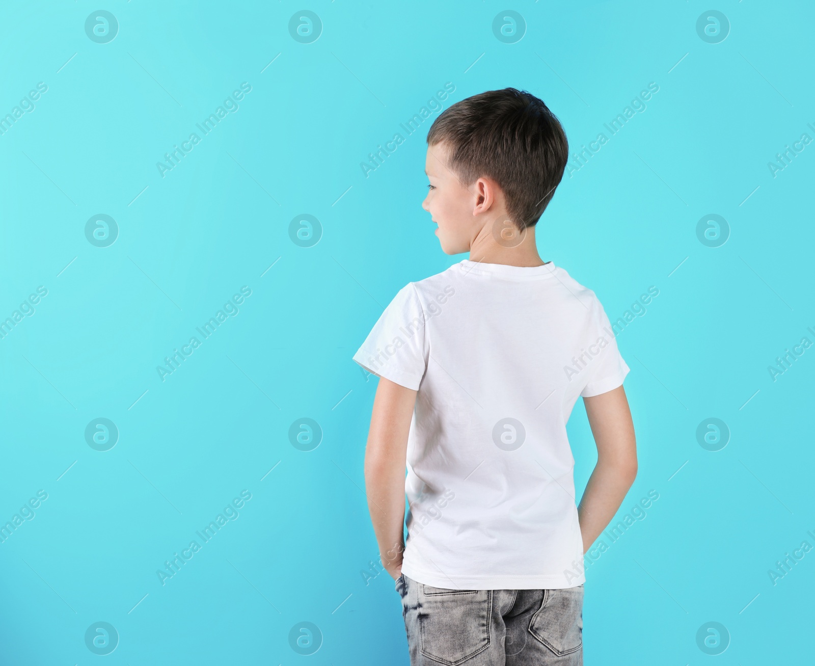 Photo of Little boy in t-shirt on color background. Mock-up for design