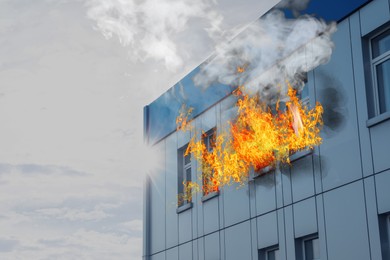 Modern building engulfed in flames. Fire safety violations