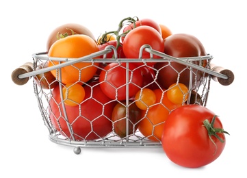 Fresh ripe yellow and red tomatoes in metal basket on white background