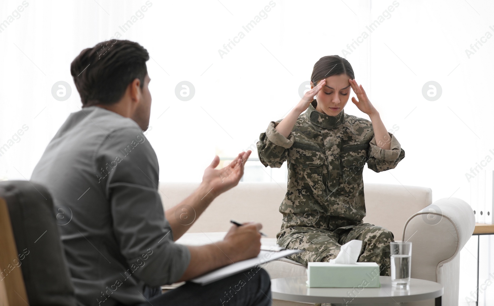 Photo of Psychotherapist working with female military officer in office