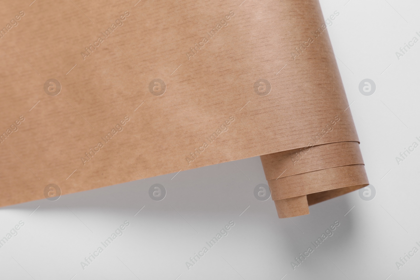 Photo of Roll of wrapping paper on white background, top view