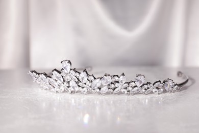 Beautiful silver tiara with diamonds on white table
