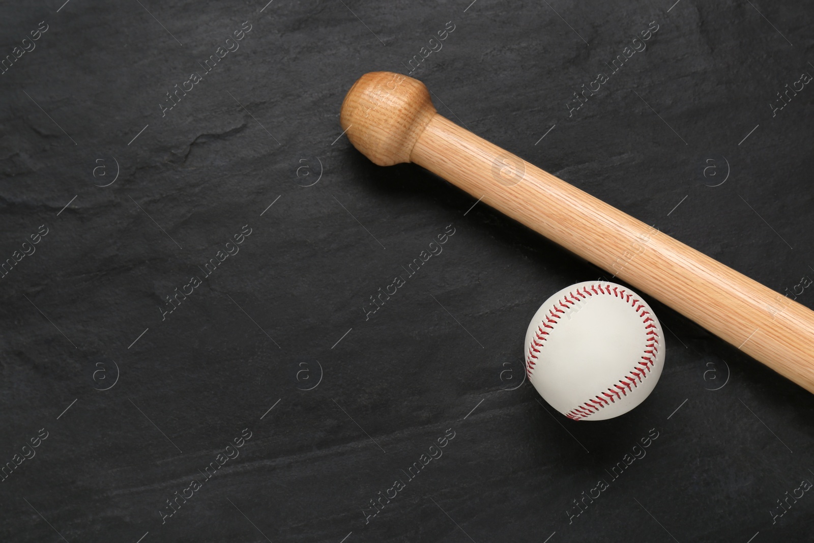 Photo of Baseball bat and ball on black background, top view with space for text. Sports equipment