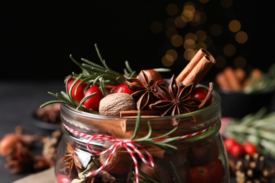 Photo of Aroma potpourri with different spices in jar, closeup view