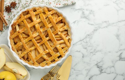 Photo of Tasty homemade quince pie served on white marble table, flat lay. Space for text
