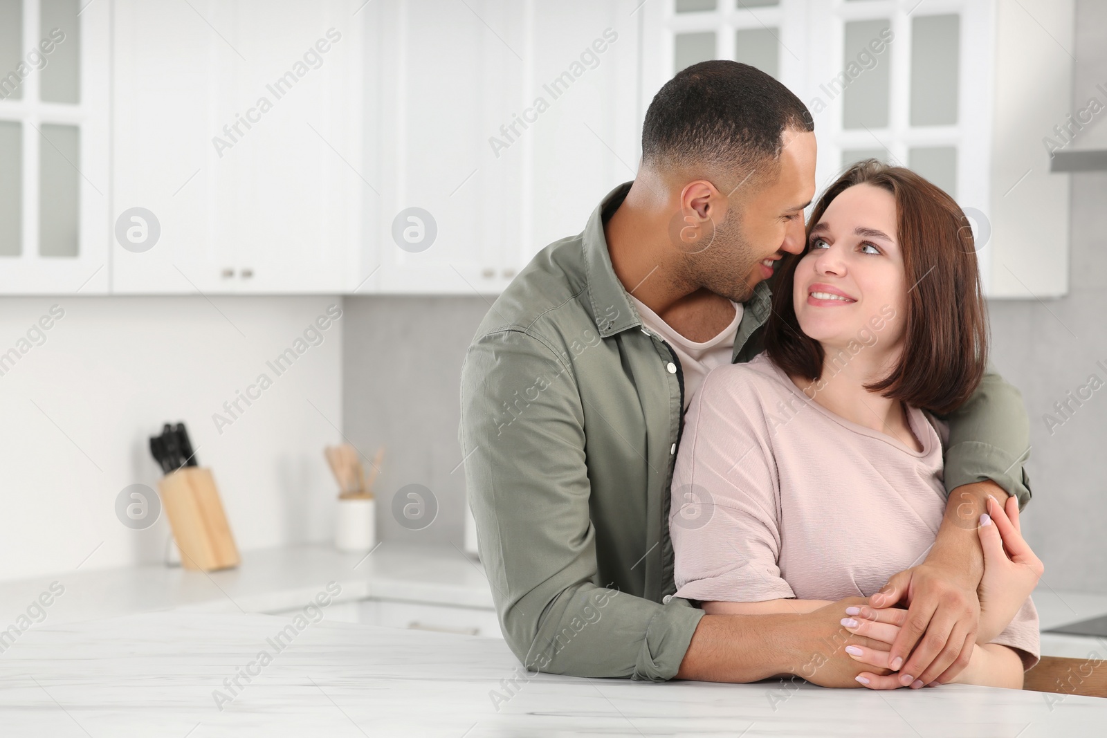 Photo of Dating agency. Happy couple spending time together in kitchen, space for text