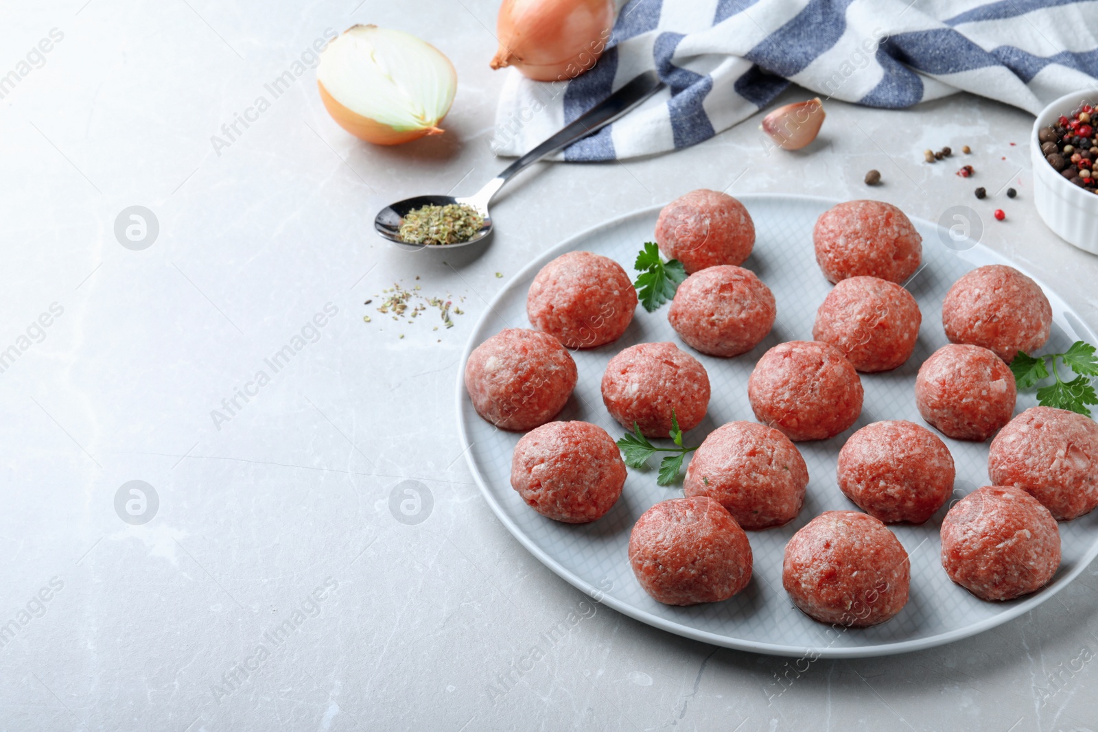 Photo of Many fresh raw meatballs on light table, space for text