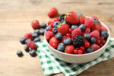 Photo of Mix of ripe berries on wooden table