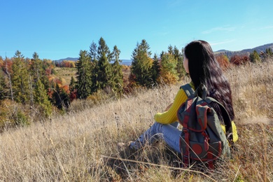 Photo of Female traveler viewing peaceful mountain landscape