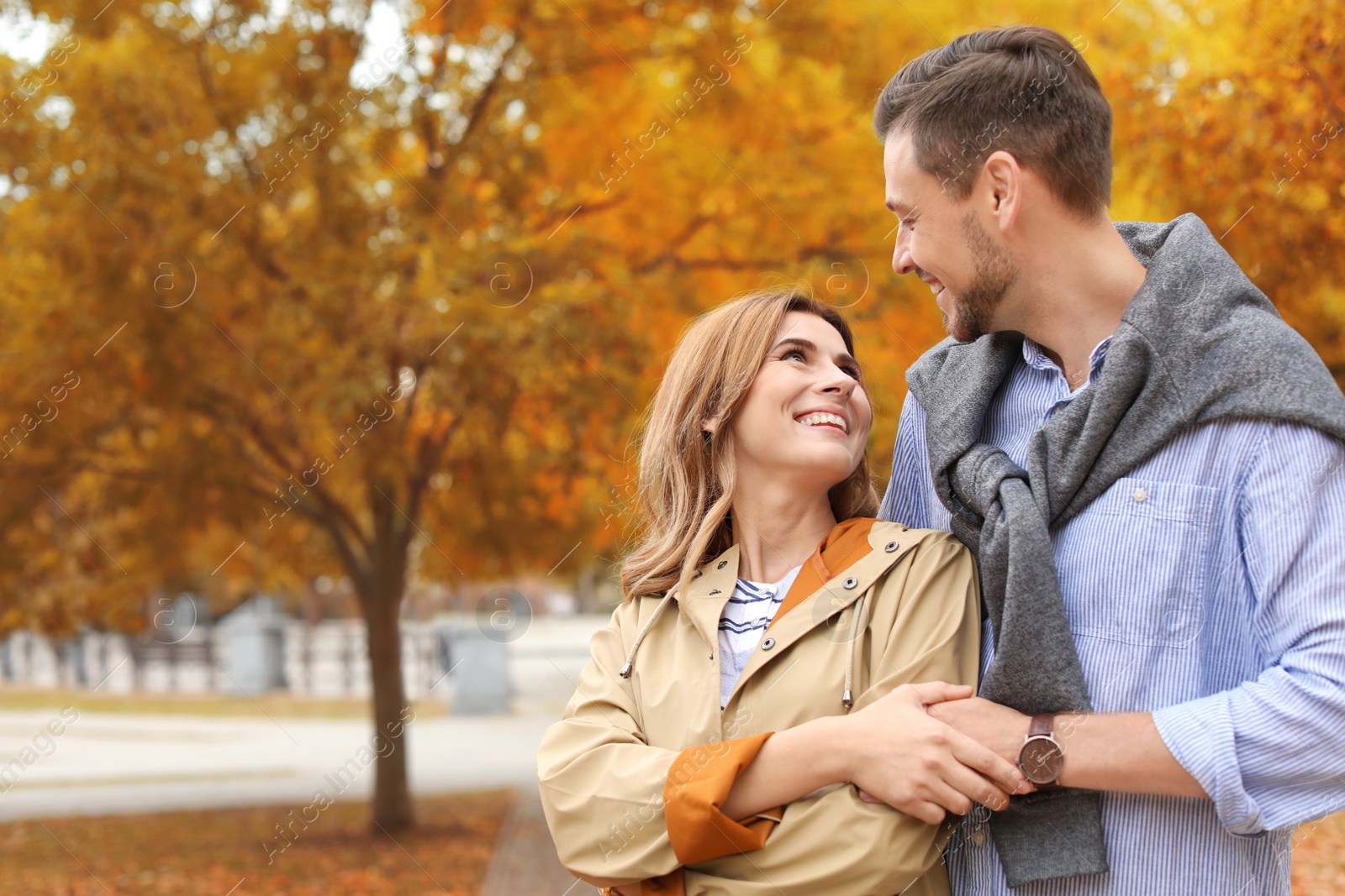 Photo of Lovely couple spending time together in park. Autumn walk