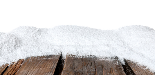 Photo of Heap of snow on wooden surface against white background