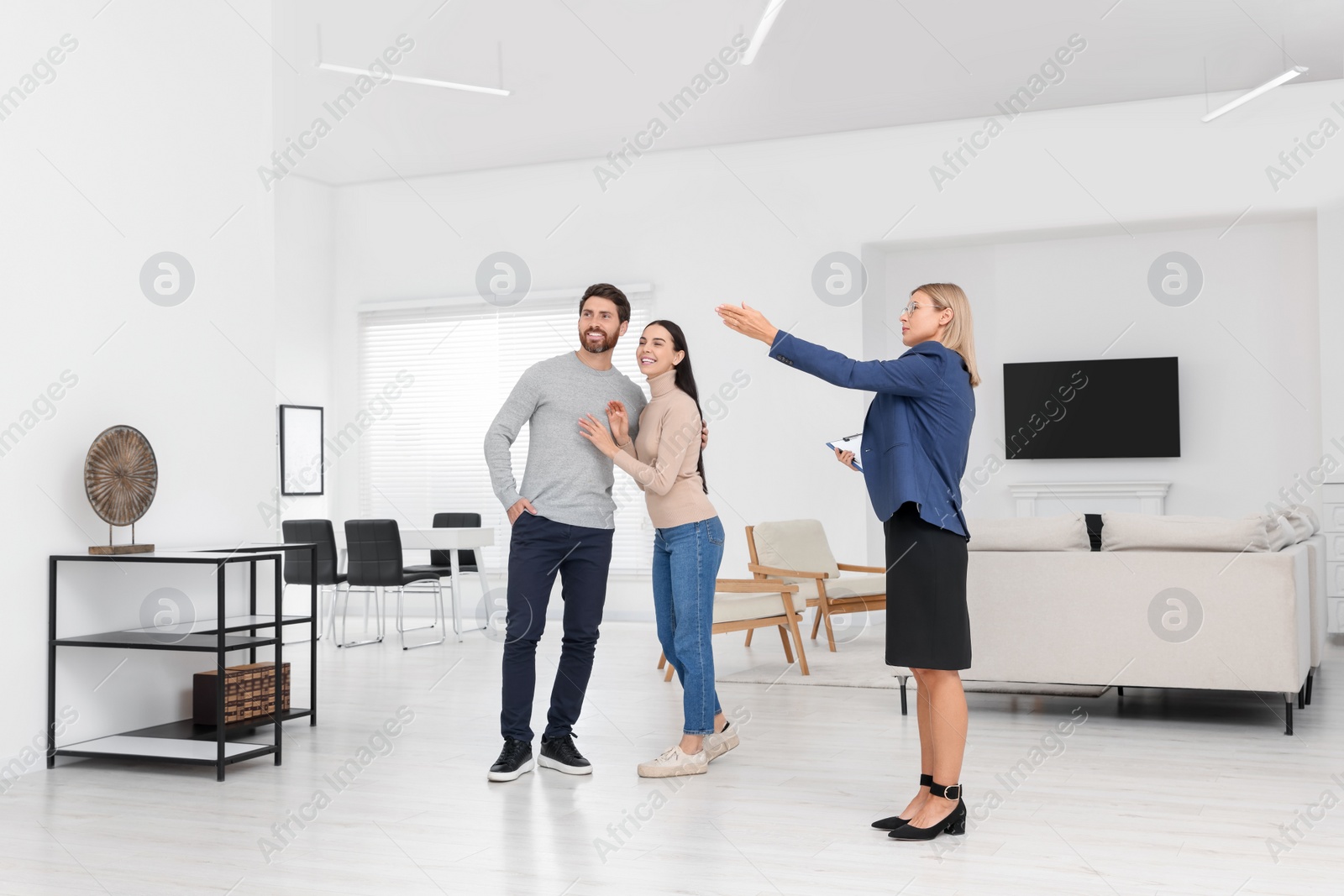 Photo of Real estate agent showing new apartment to couple