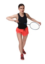 Young woman playing badminton with racket on white background