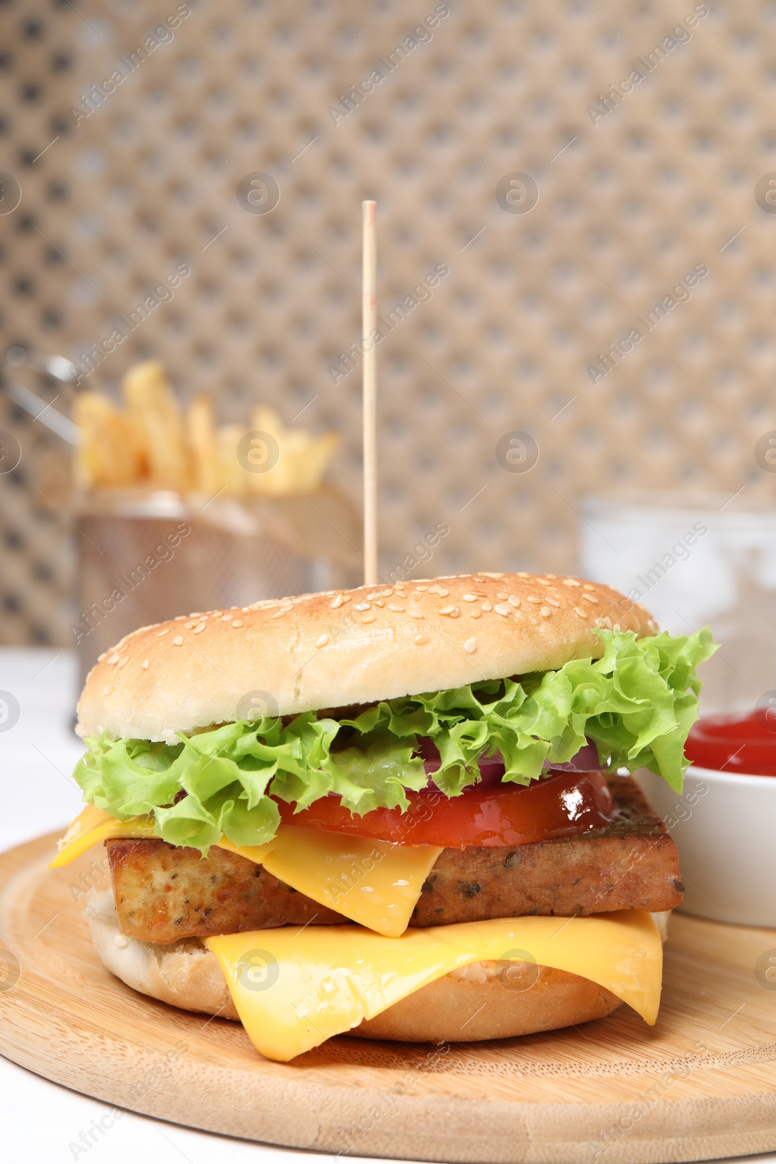 Photo of Delicious burger with tofu and fresh vegetables on white table