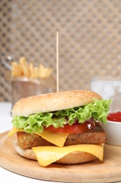 Delicious burger with tofu and fresh vegetables on white table