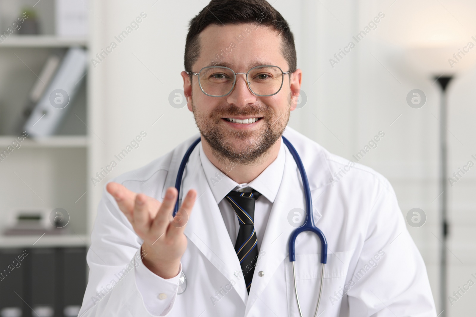 Photo of Portrait of smiling doctor with stethoscope indoors