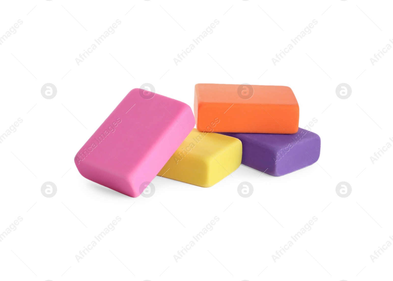 Photo of Pile of bright erasers on white background