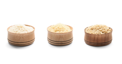 Bowls with different types of uncooked rice on white background