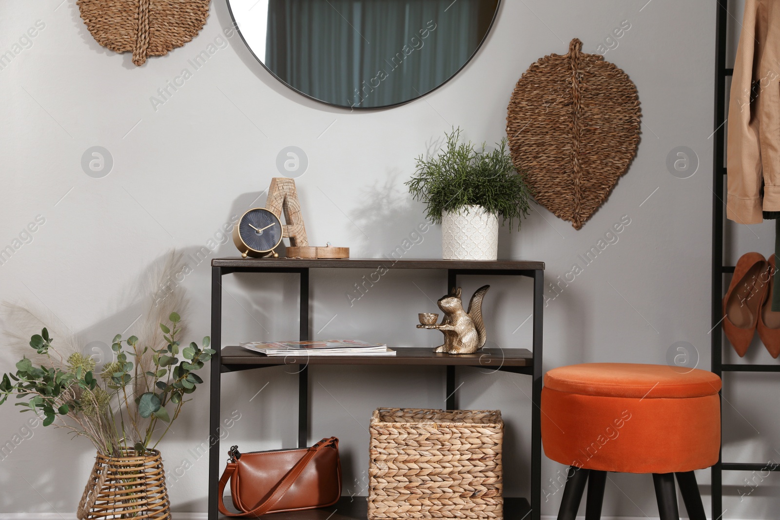 Photo of Stylish room interior with console table and beautiful decor elements