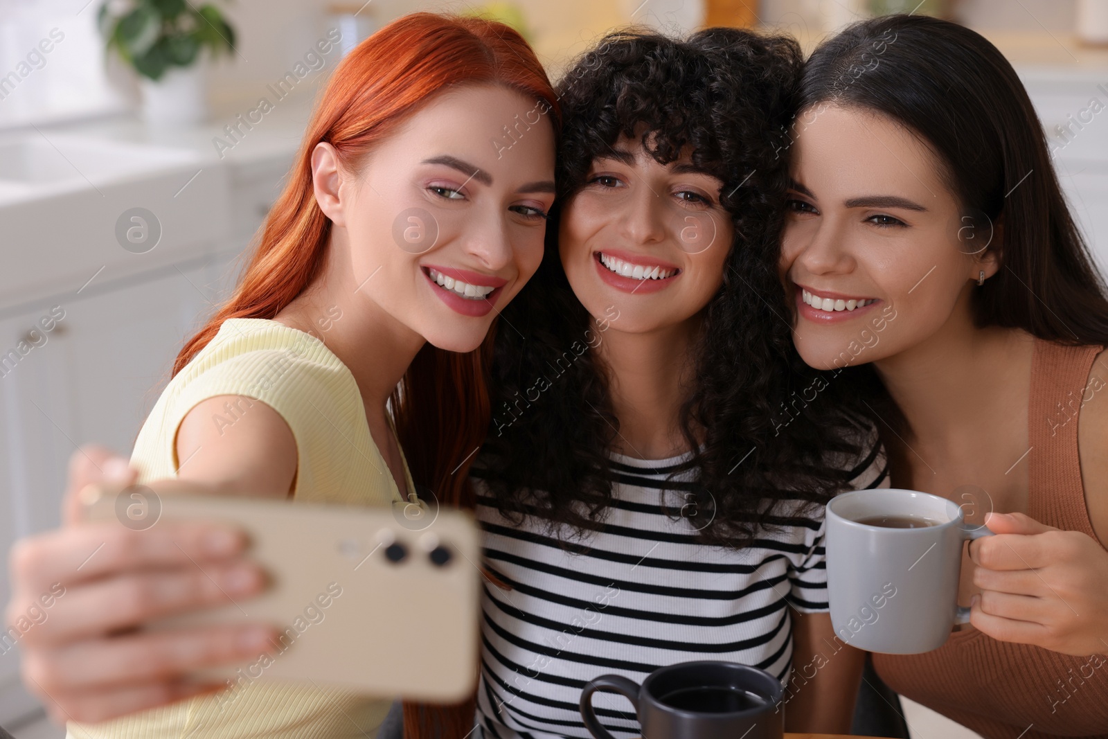 Photo of Happy young friends taking selfie at home