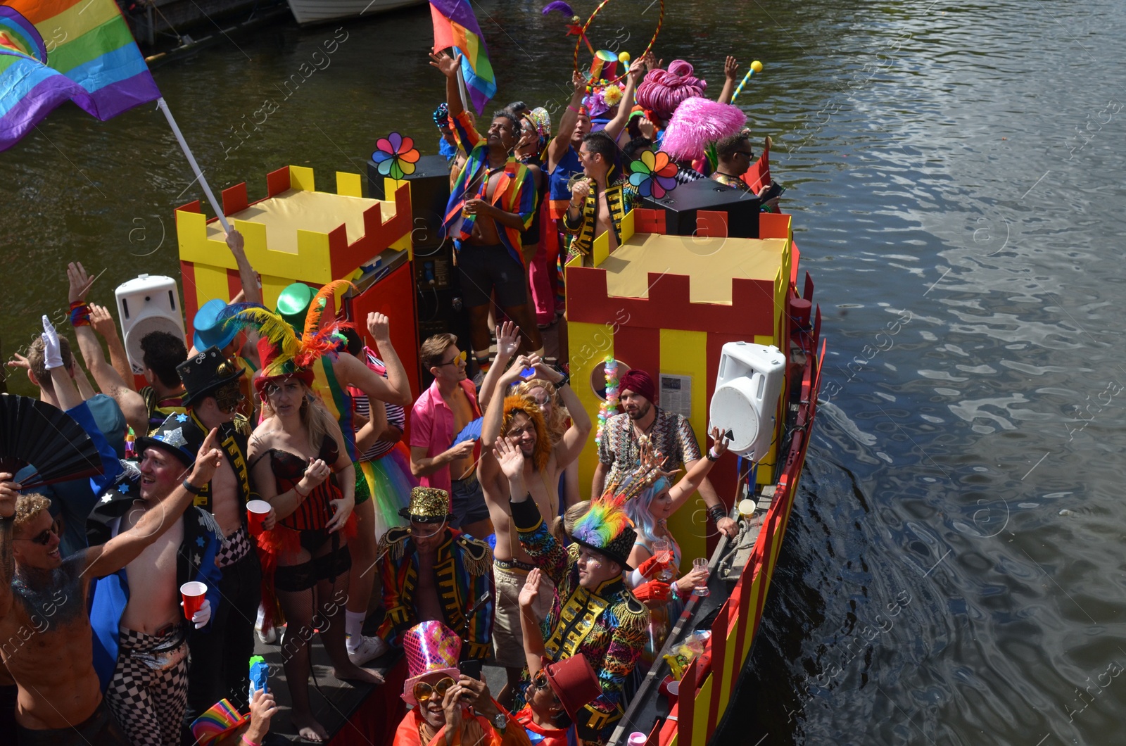 Photo of AMSTERDAM, NETHERLANDS - AUGUST 06, 2022: Many people in boat at LGBT pride parade on river