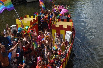 AMSTERDAM, NETHERLANDS - AUGUST 06, 2022: Many people in boat at LGBT pride parade on river