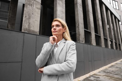 Photo of Portrait of thoughtful woman outdoors. Lawyer, businesswoman, accountant or manager