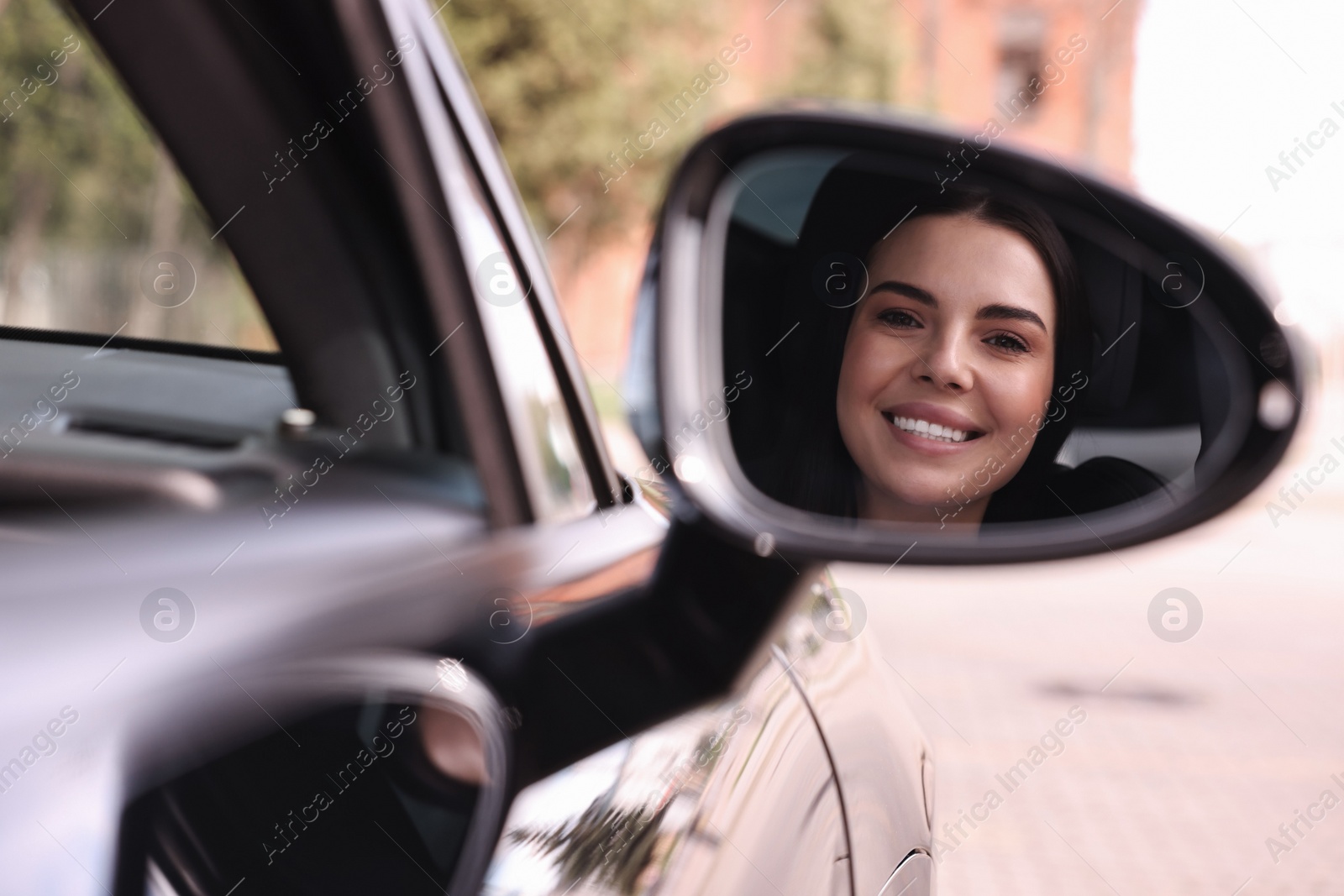 Photo of Woman with safety seat belt driving her modern car