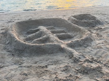 Palm tree made of sand on beach