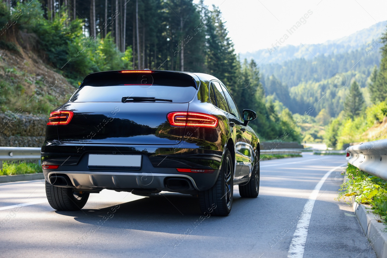 Photo of Picturesque view of asphalt road with modern car