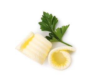 Photo of Tasty butter curls and fresh parsley isolated on white, top view