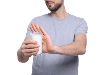 Photo of Man with glass of milk suffering from lactose intolerance on white background, closeup