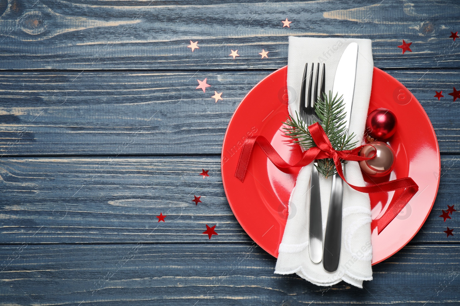 Photo of Christmas table setting on blue wooden background, top view. Space for text