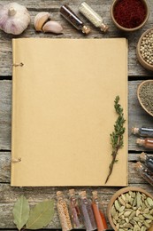Photo of Blank recipe book and different ingredients on old wooden table, flat lay. Space for text