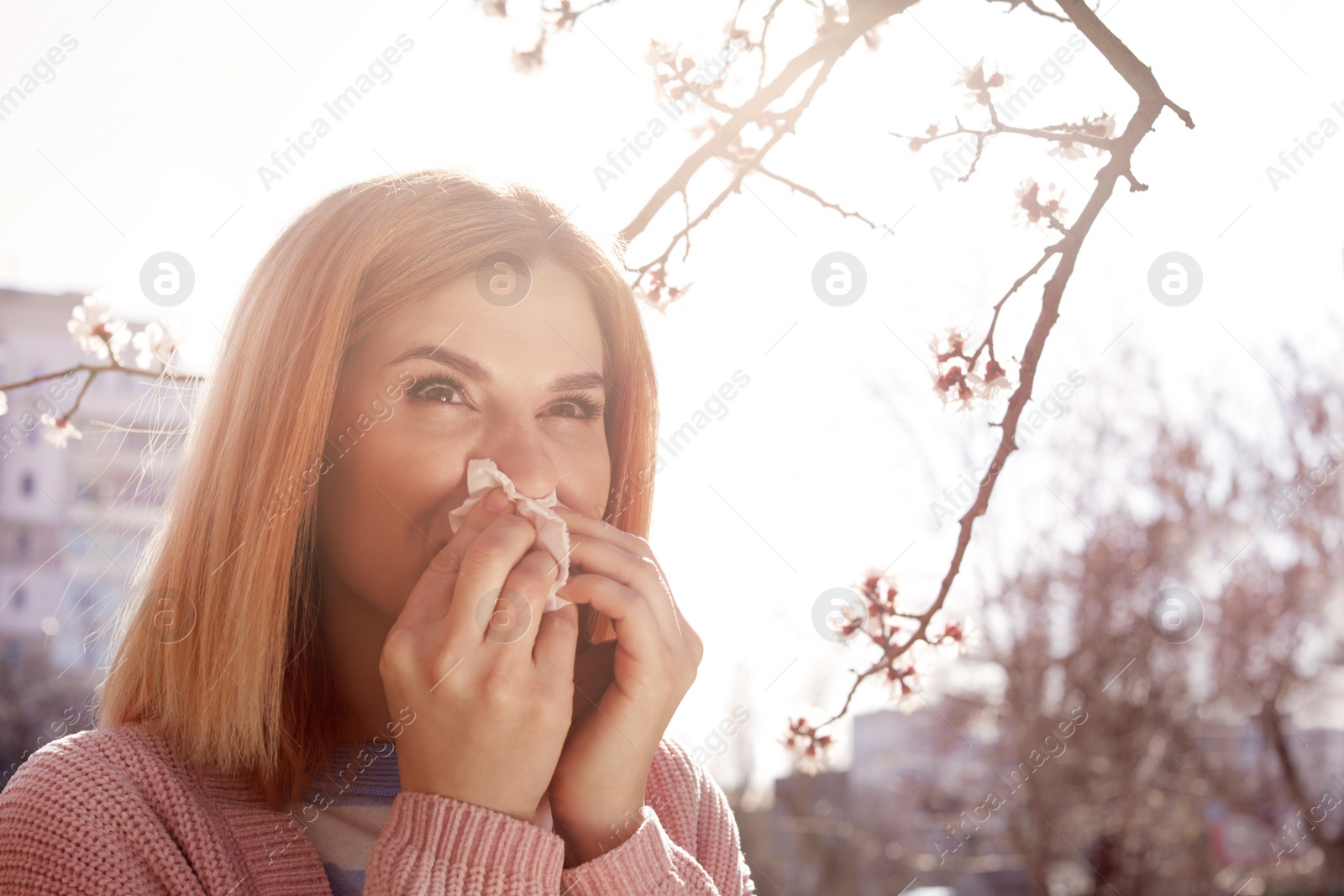 Photo of Woman suffering from seasonal allergy outdoors, space for text